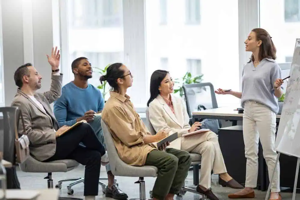 Team brainstorming session in a modern office, showcasing diversity and collaboration during a professional presentation.