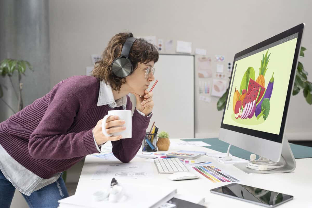 A designer looking at a computer screen displaying fruits. testimonial