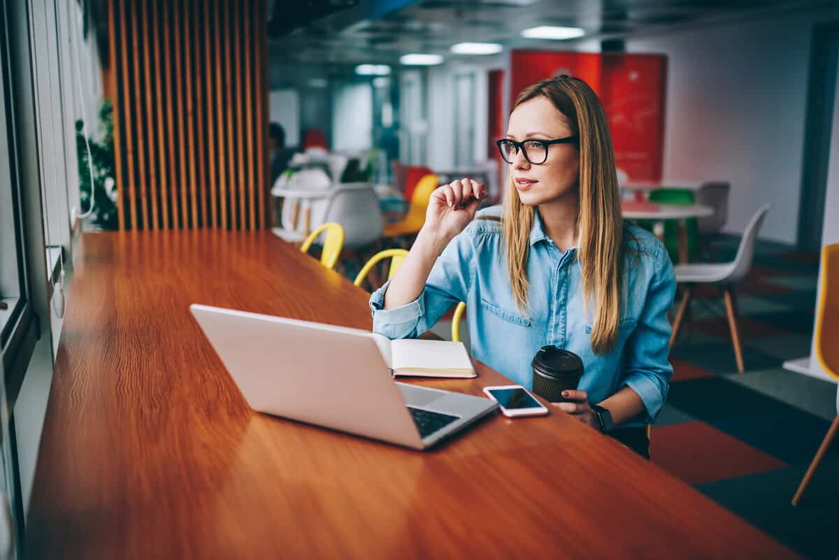 Social Media manager working on social media post at the office. testimonial