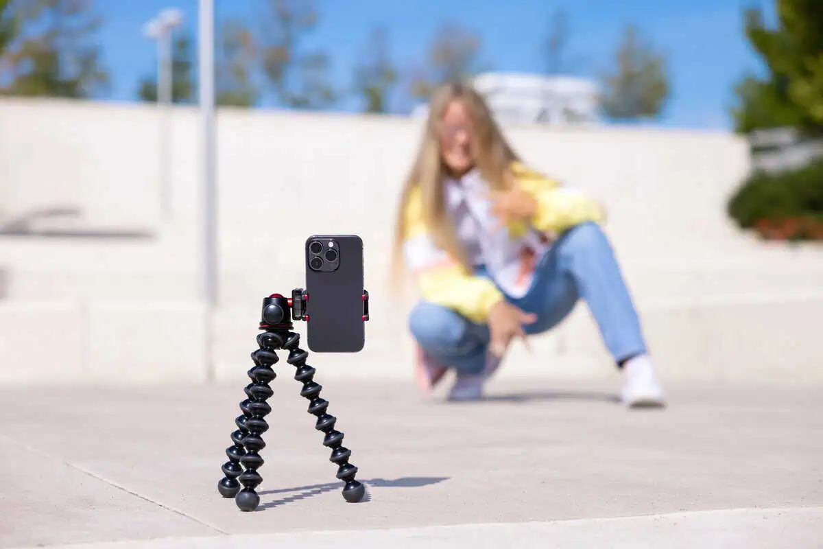 Girl making video of herself on mobile phone.