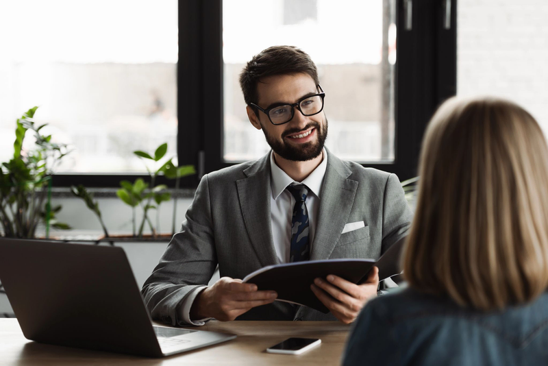 Company representatives discuss business with staffing partner.